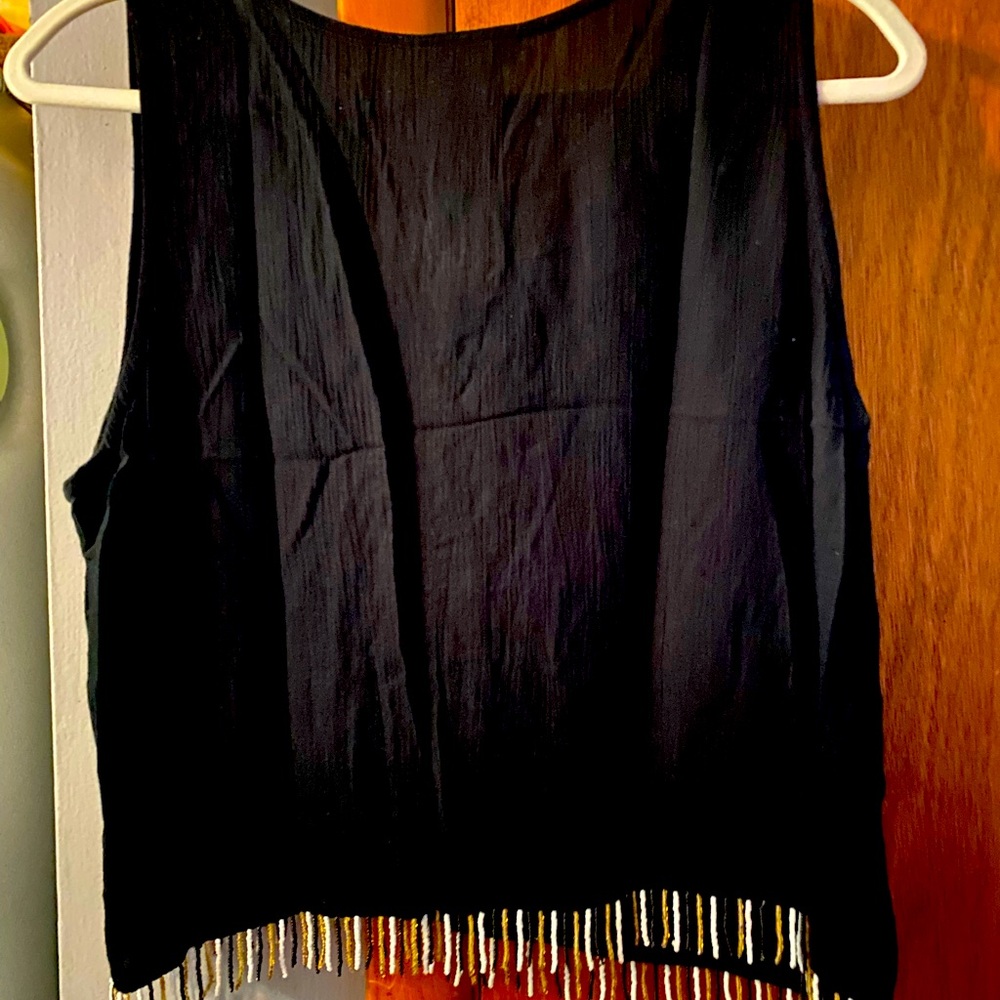 Tan black with pattern and fringe around waist, short. Part of 5 piece set